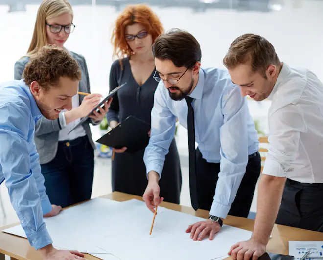 Team of engineers discussing plans during a meeting