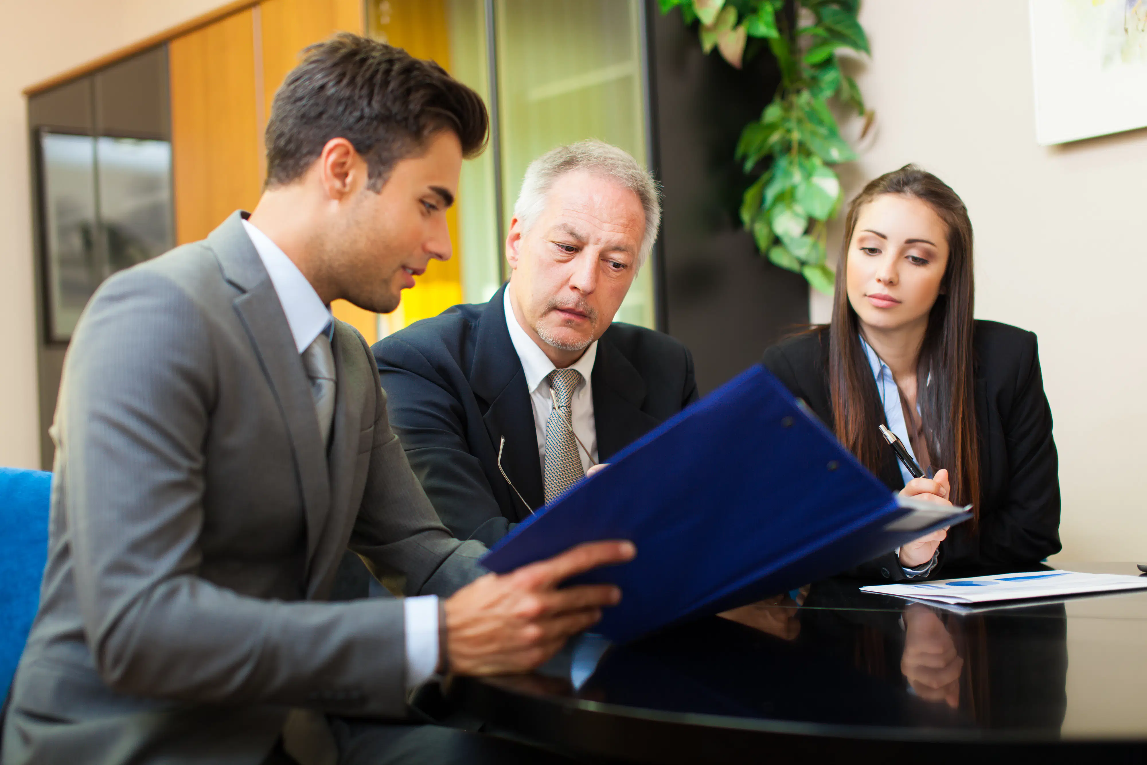 Lawyer discussing with clients. Study an LL.M. degree abroad to advance your law career.