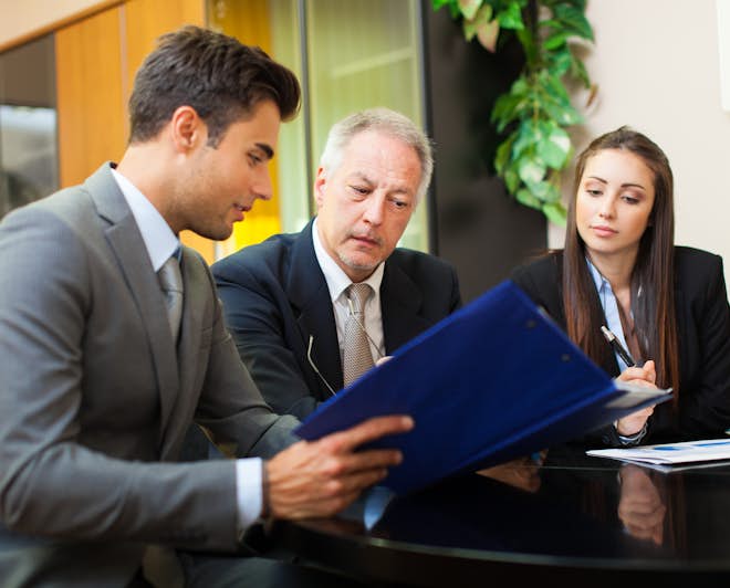 Lawyer discussing with clients. Study an LL.M. degree abroad to advance your law career.