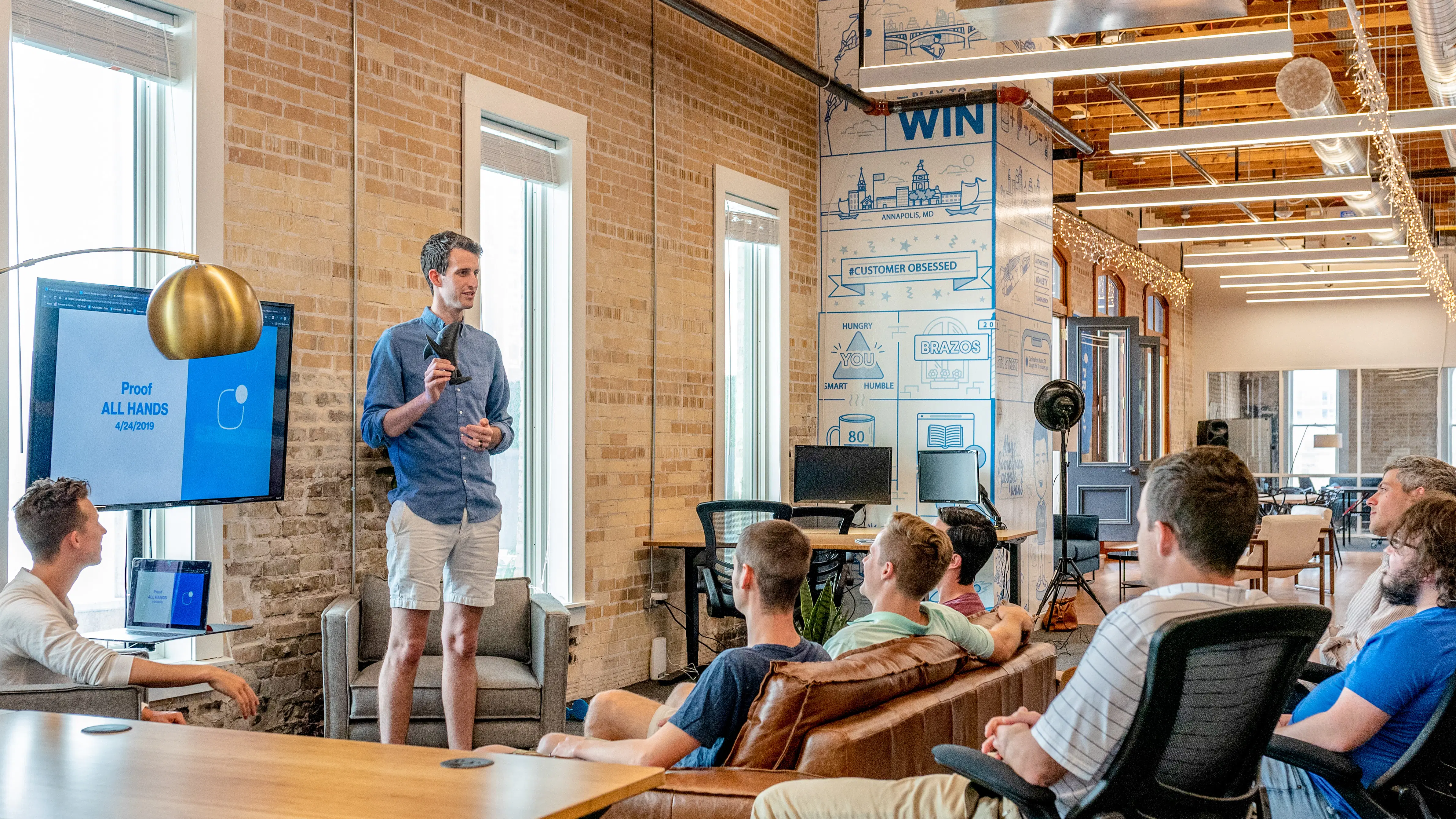 Man holds a speech in front of his colleagues during a business meeting