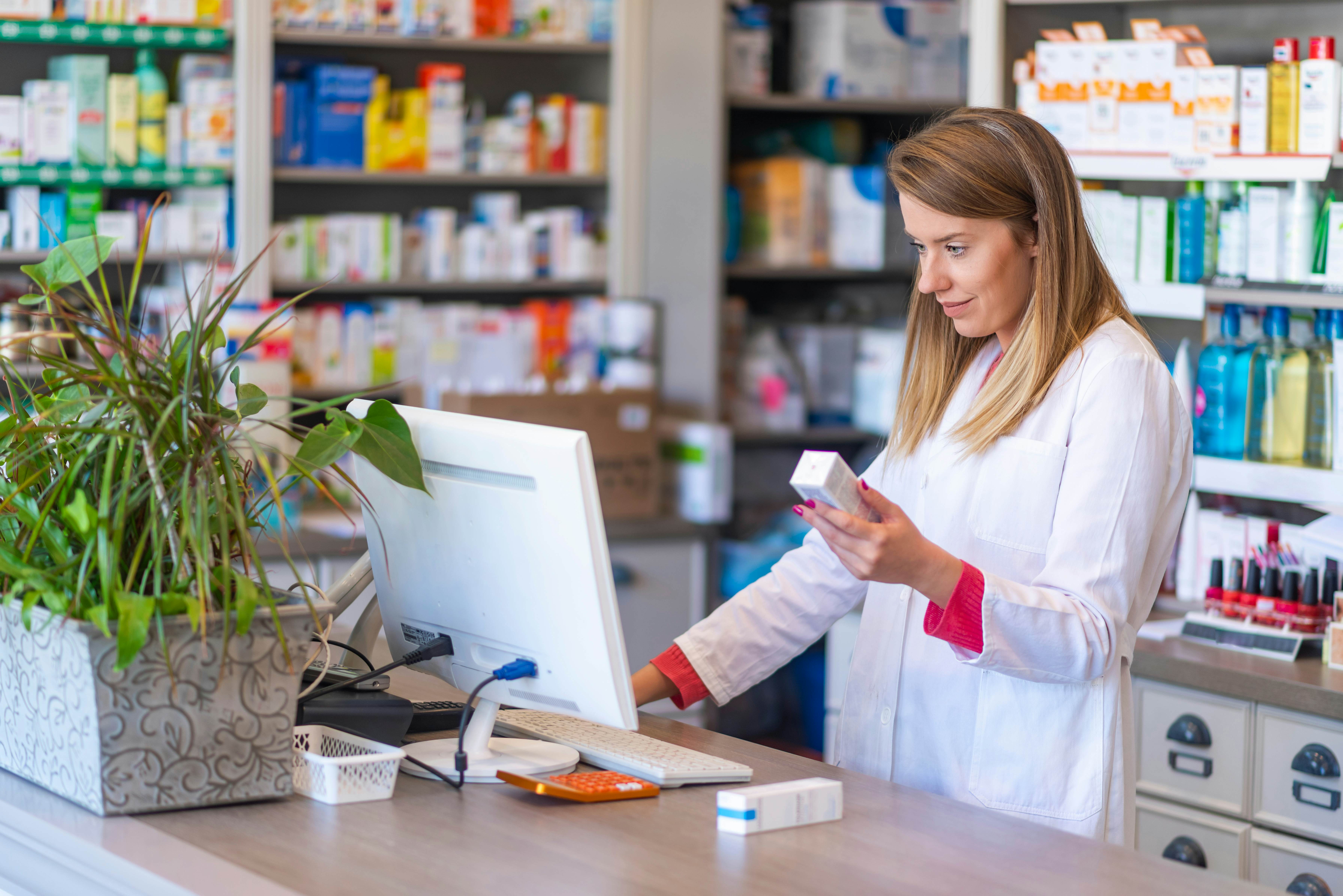 Female pharmacist working in a drug store or pharmacy