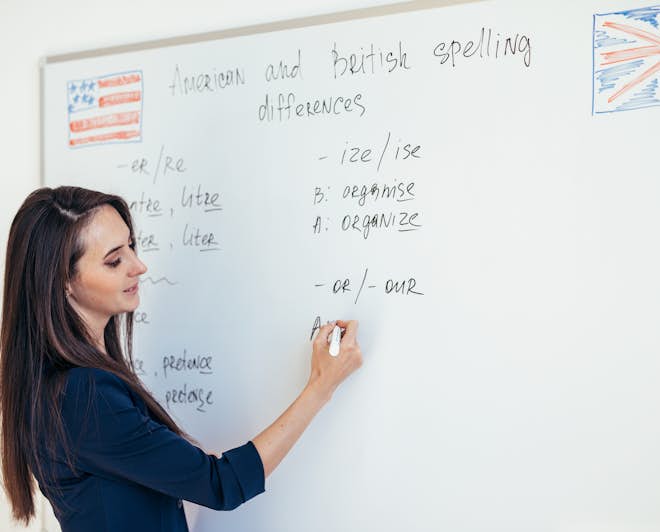Female teacher explaining the differences between British and American spelling