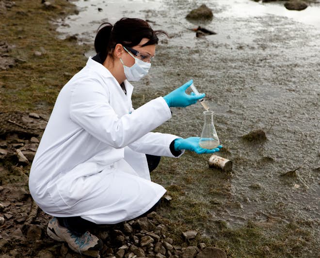 Female environmental scientist taking a water sample