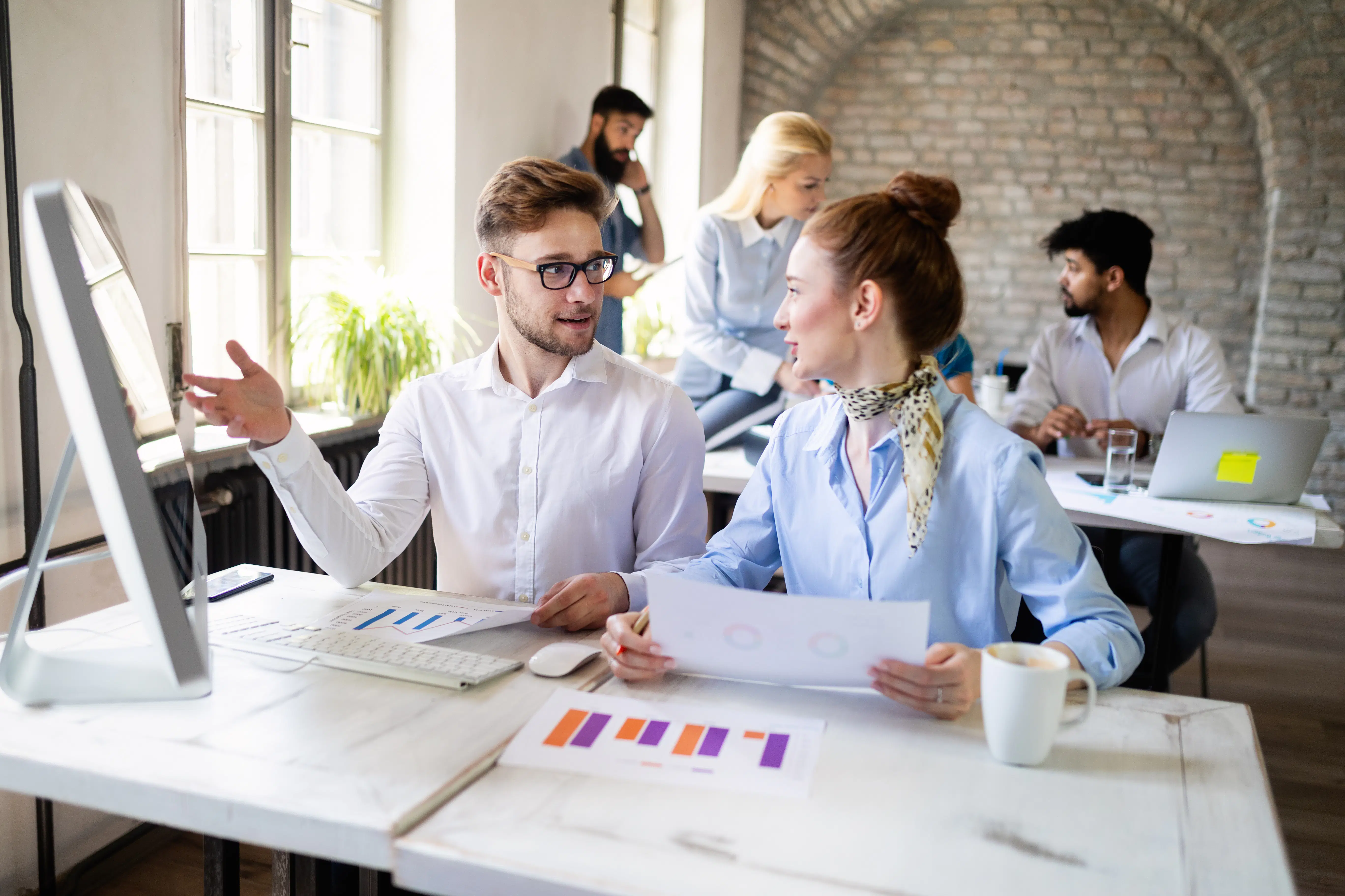 Two business colleagues discussing about reports
