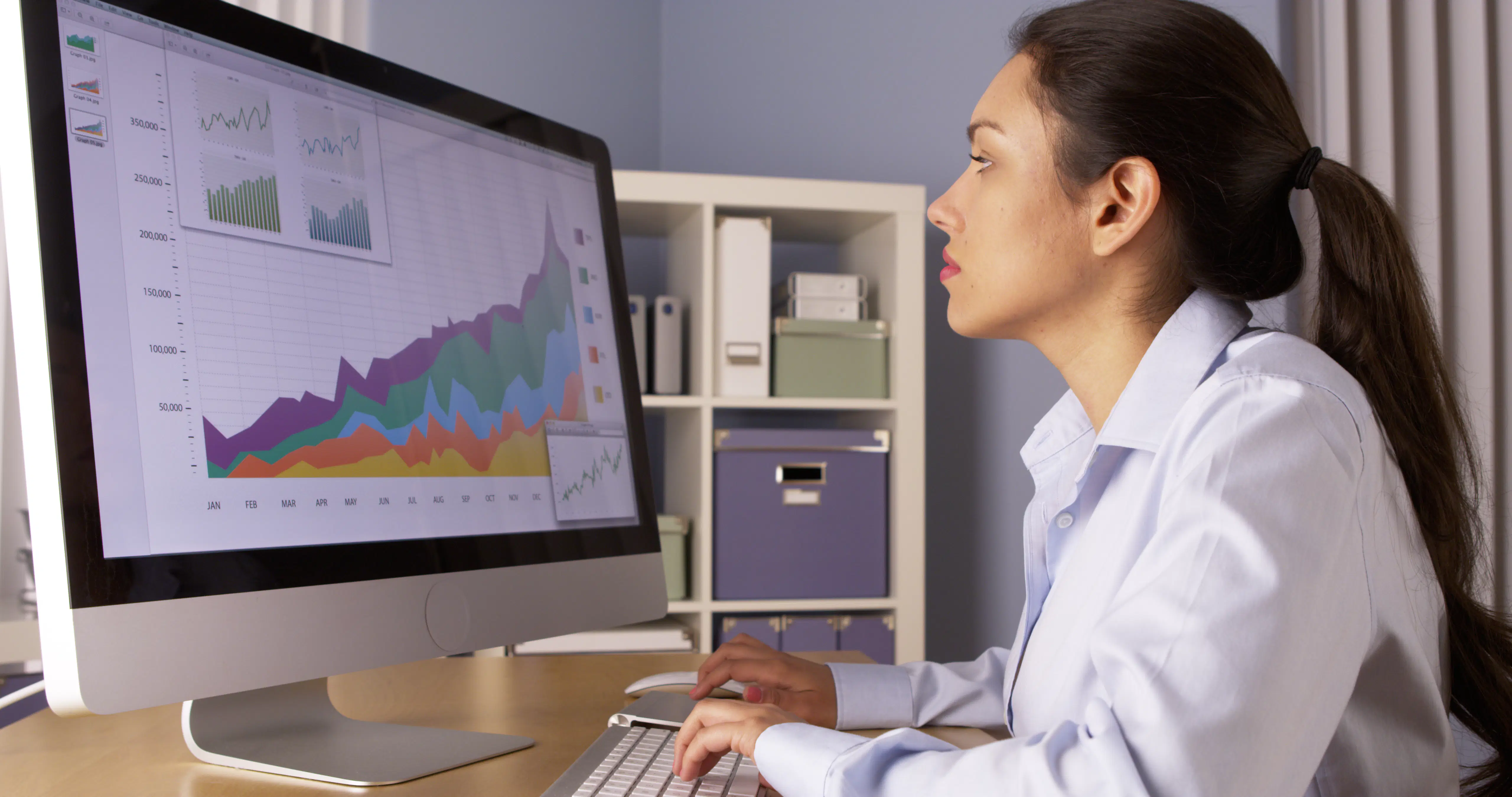 Data analyst examining information displayed on her desktop