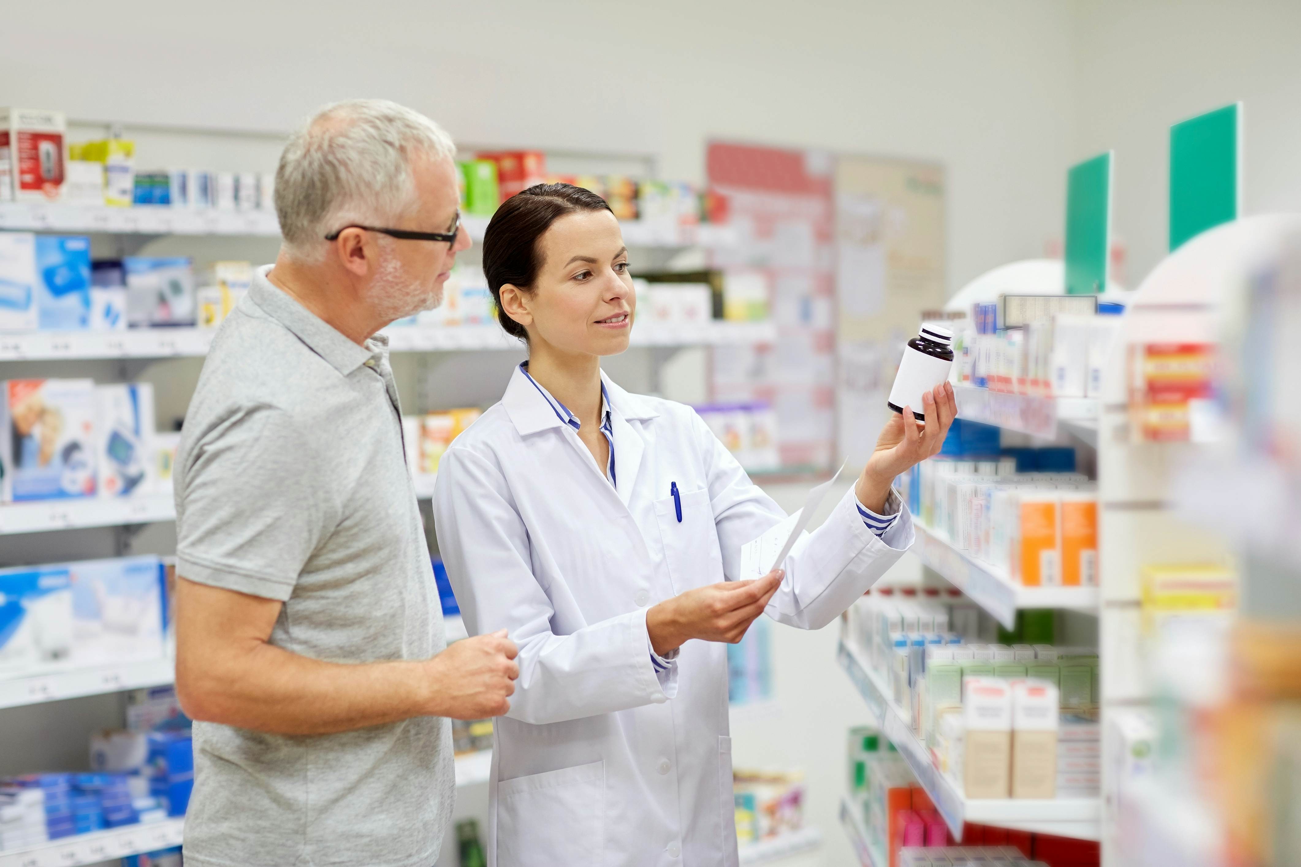 Pharmacist offering drugs to patient