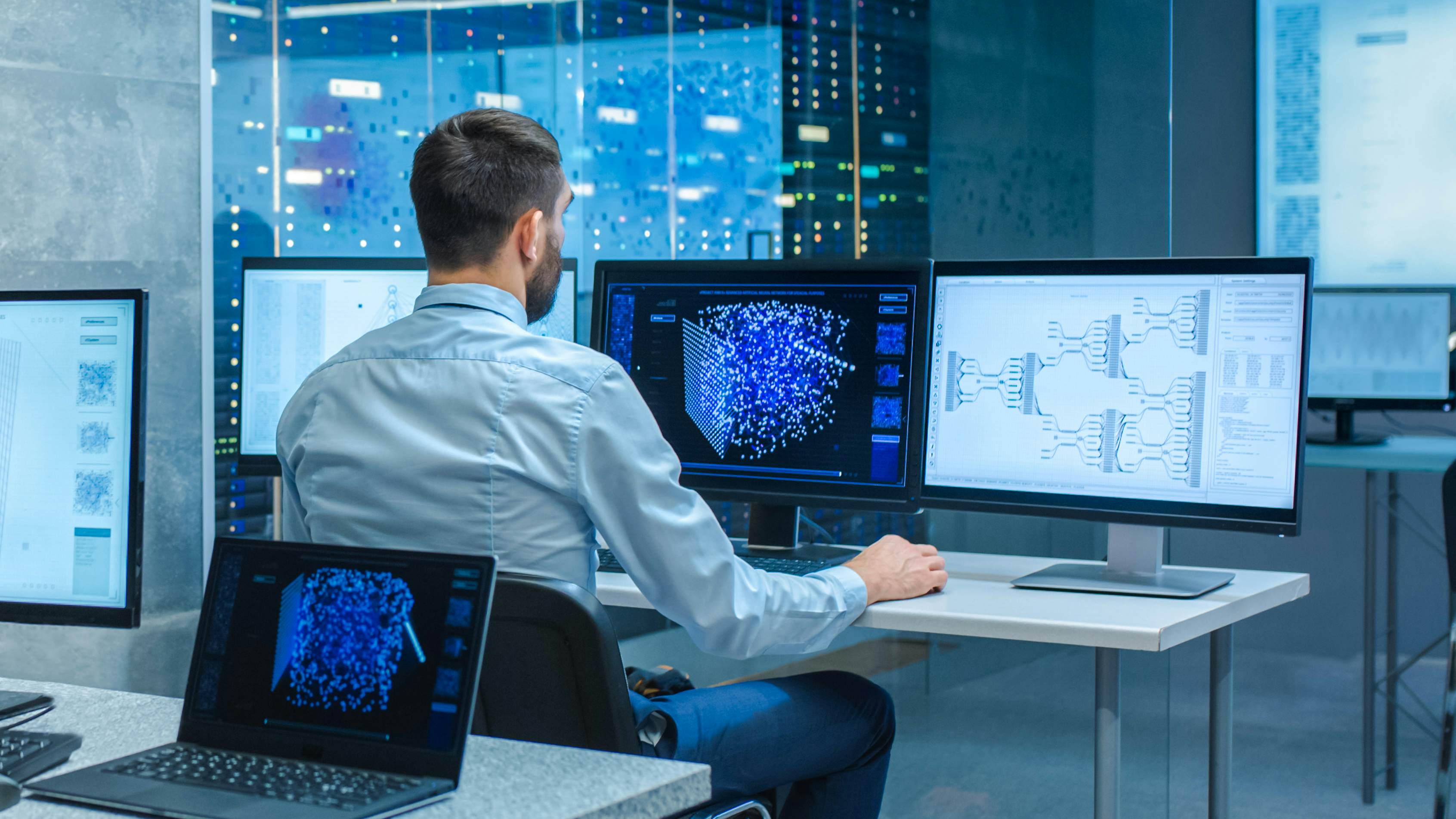 Computer scientist working on a neural network at his desk