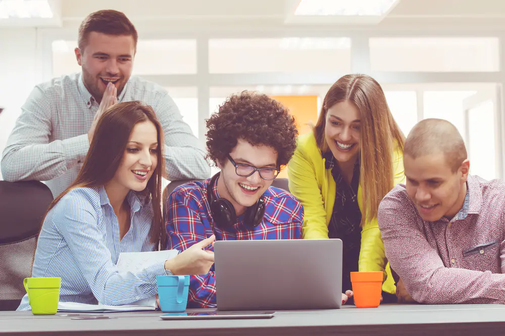 Students looking at a laptop