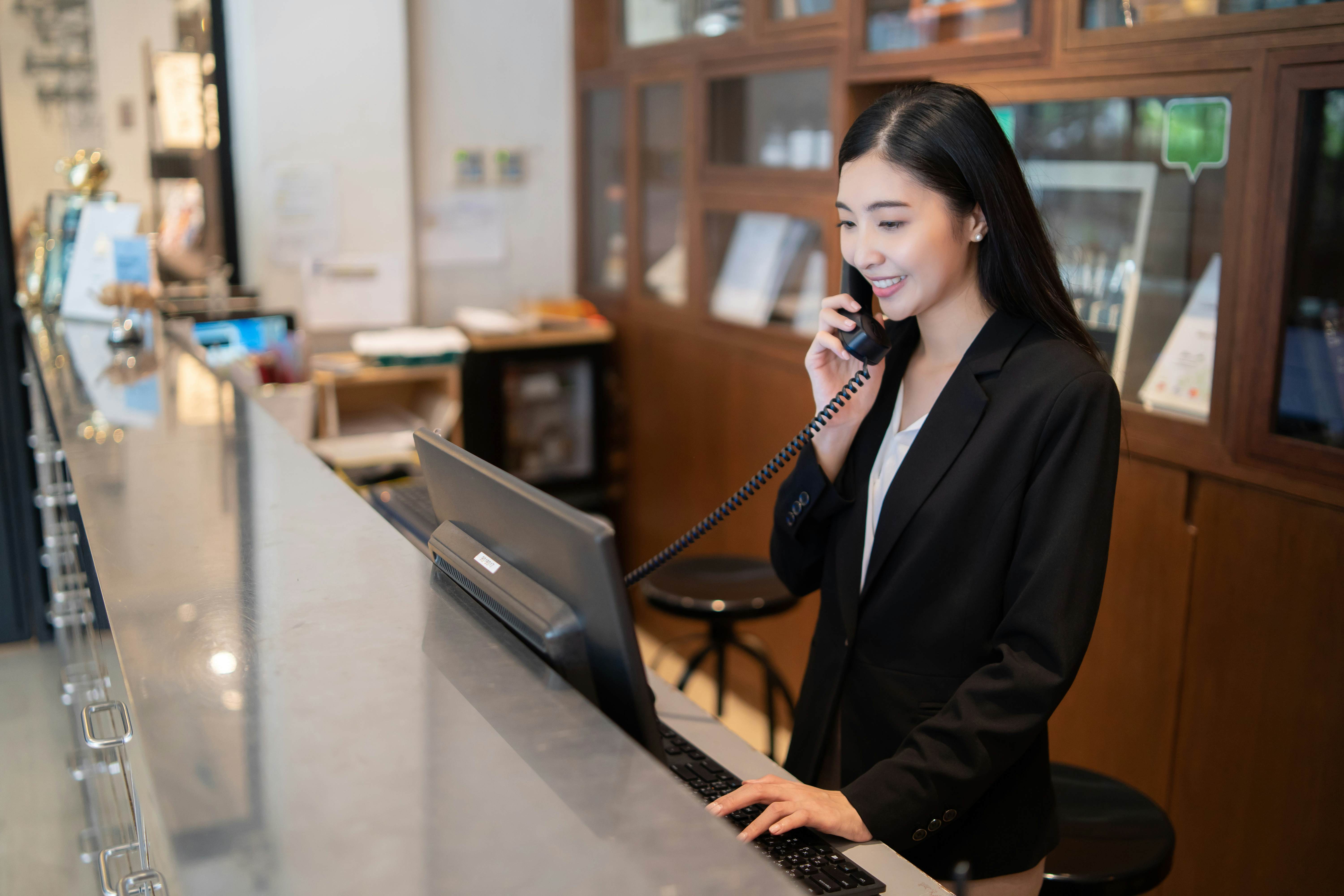 Female hotel receptionist talking on the phone