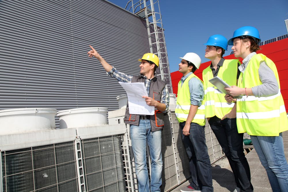 Civil engineer talking with construction workers about a project