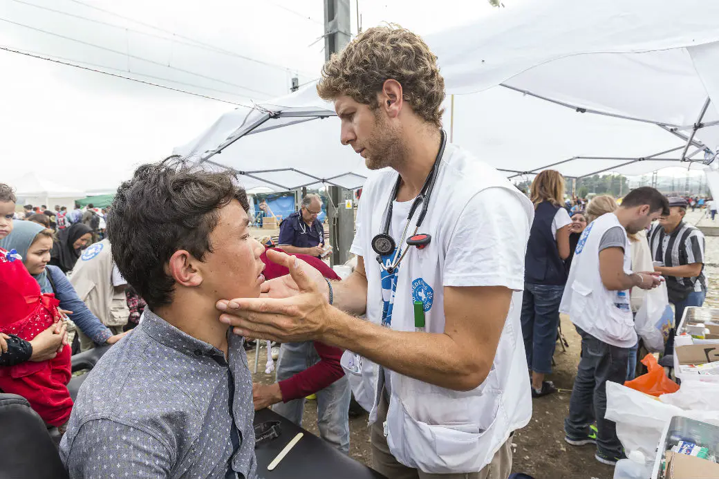 Public health consultant examining patient